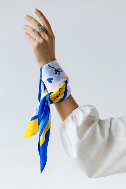 Fragile and tender female hand on a white background with a shawl