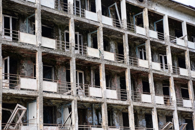 Fragment of an abandoned residential multistorey building Destroyed balconies lack of windows and doors