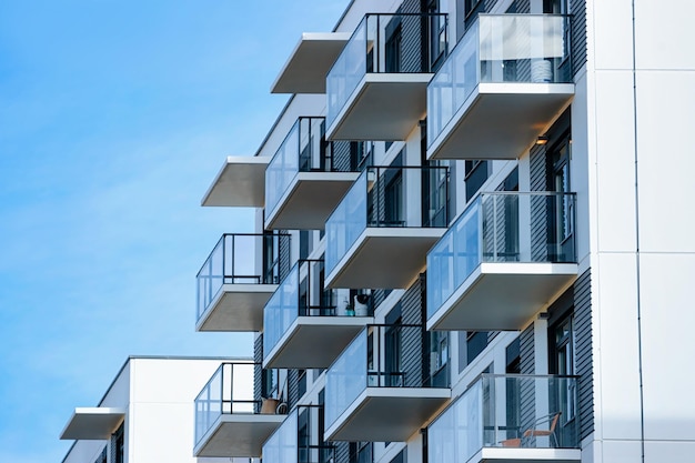 Fragment of Apartment house residential building complex real estate concept. Place for copy space. With blue sky