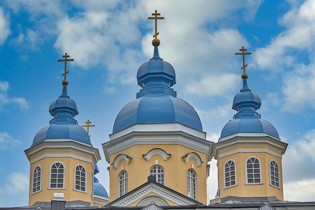 Fragment of the bell tower of a Christian church with a blue roof