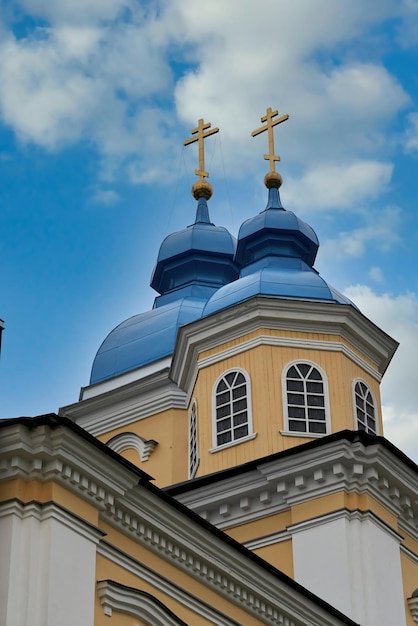 Fragment of the bell tower of a christian church with a blue roof