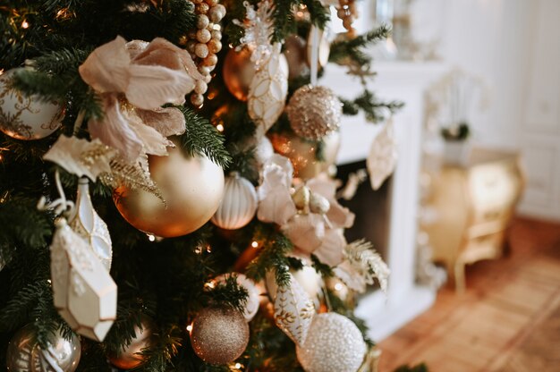 A fragment of a Christmas decorated tree in warm golden hues 