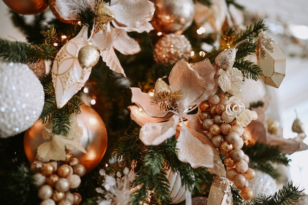 A fragment of a Christmas decorated tree in warm golden hues