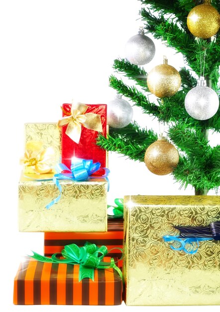 Fragment of Christmas and New Year Tree with gift boxes. Isolated over white background.