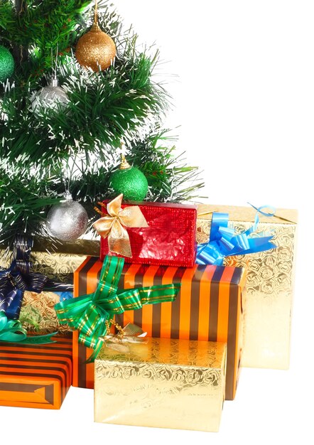 Fragment of Christmas and New Year Tree with gift boxes. Isolated over white background.