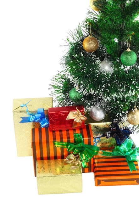 Fragment of Christmas and New Year Tree with gift boxes. Isolated over white background.