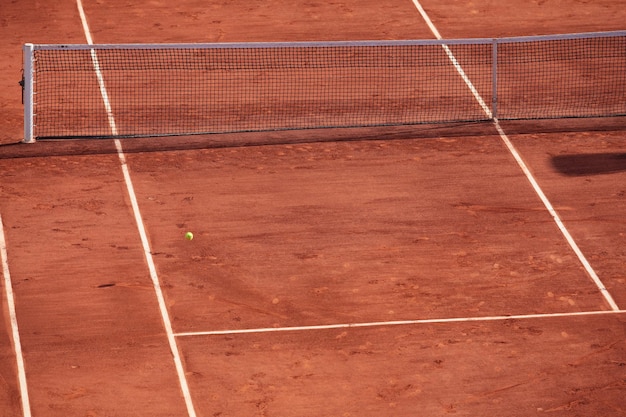 Fragment of clay tennis court grid and marking lines visible\
selective focus design element