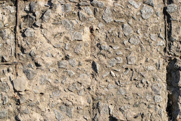 Fragment Of A Concrete Wall With A Rusty Wire Mesh