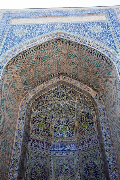 A fragment of the facade of a madrasah decorated with mosaics on Registan Square in Samarkand, Uzbekistan.