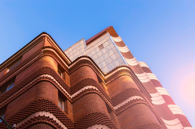 Fragment of the facade of a modern residential building made of bricks abstract background