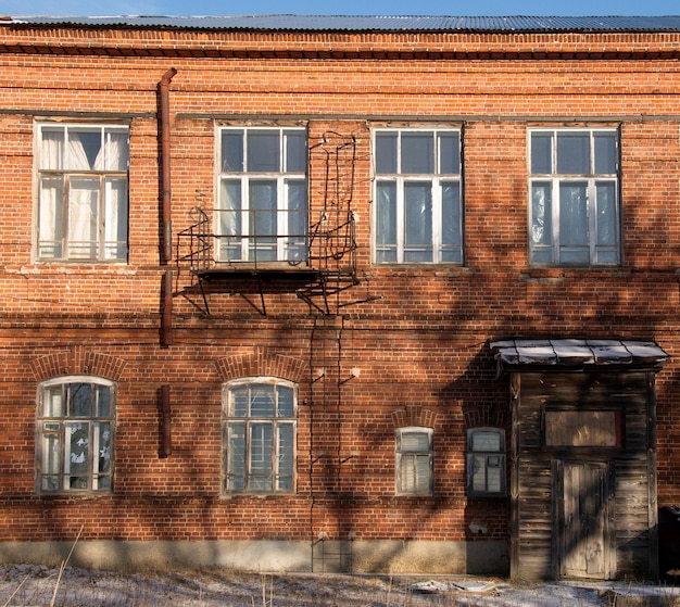 Fragment of the facade of an old red brick building