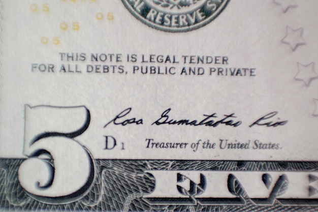 Photo fragment of five dollars bill with figure five