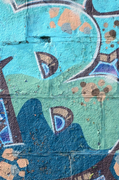 落書きの絵の断片ストリートアート文化のスタイルでペンキの染みで飾られた古い壁冷たい色調の色付きの背景テクスチャ