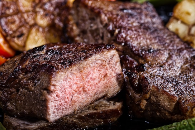 Fragment of juicy roasted steak with blood