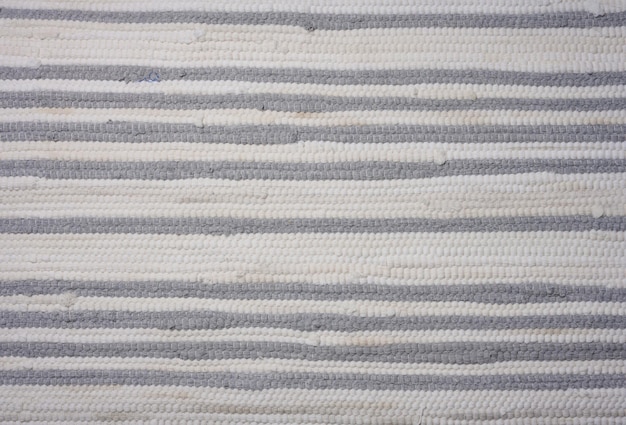 Fragment of a knitted whitegray fabric close up