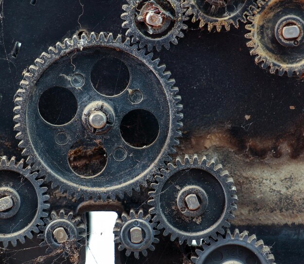 Photo fragment of the machine plastic dusty and dirty gears