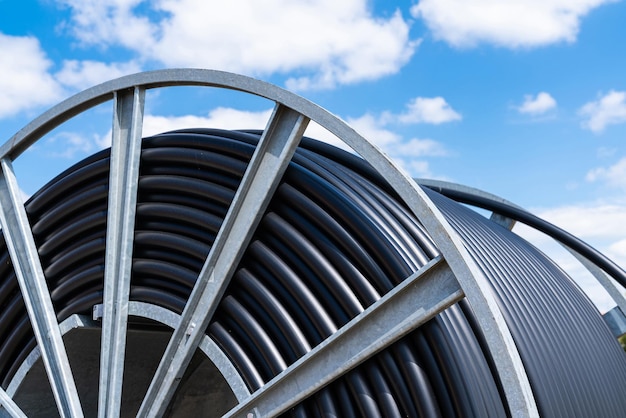 Fragment of a metal coil with a black electric cable