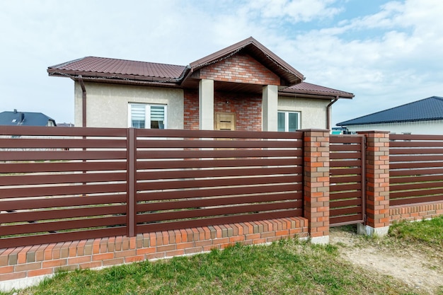 Fragment of a modern fence lined with decorative bricks in the old style