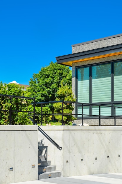 Fragment of modern house on land terace with concrete stairs to the upper land