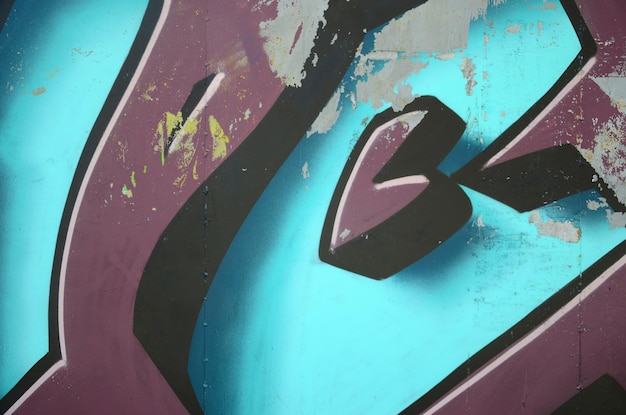 Фото Фрагмент рисунков граффити старая стена украшена пятнами краски в стиле уличной культуры цветной текстуры фона в холодных тонах
