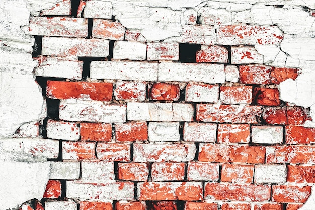 Fragment of old crumbling brick wall shot close-up with backlight