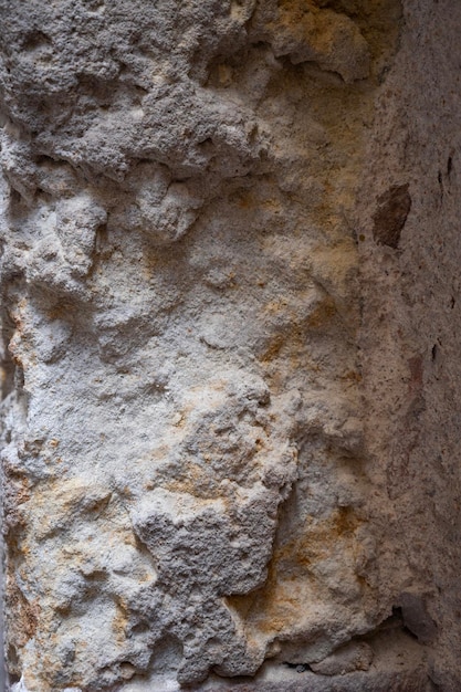 Fragment of old stone wall Rough textured surface Wall of old house