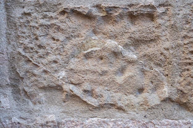 Photo fragment of old stone wall rough textured surface wall of old house