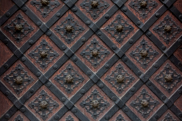 Fragment of the old wrought iron door with a pattern