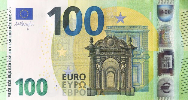 Fragment of one hundred euro money bill details of european union currency banknote of euro close