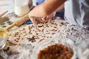 Photo fragment photo of talented bakers making cookies with raisins