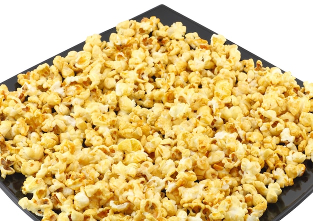 Fragment of plate with fresh caramel popcorn. Close-Up. Isolated