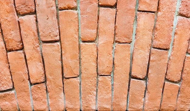 Fragment of a red brick wall with an arch