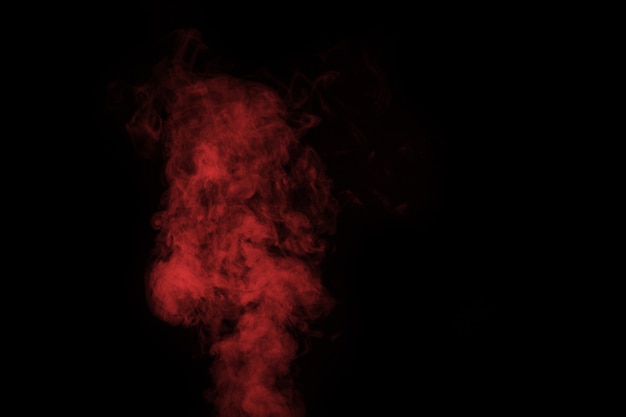 Fragment of red steam smoke isolated on a black background, close-up. Create mystical Halloween photos. Abstract background, design element