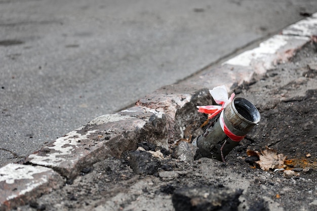 Fragment of a Russian rocket hail sticking out of the asphalt in the center of Kherson Ukraine