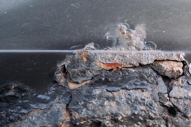 A fragment of a rusty car fender Aggressive corrosion Selective focus Closeup