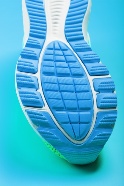 Fragment of the sole of a blue sneaker close-up