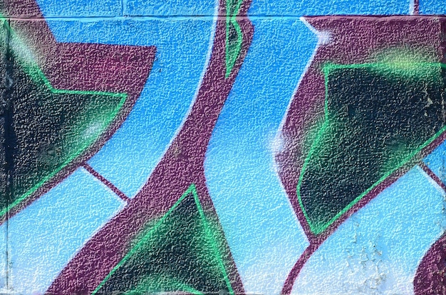 Fragment van graffititekeningen De oude muur versierd met verfvlekken in de stijl van straatkunstcultuur Gekleurde achtergrondstructuur in koude tinten