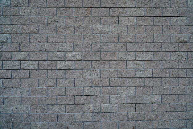 A fragment of a wall made of gray concrete blocks closeup