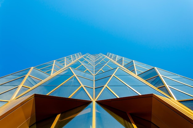 A fragment of the wall of a modern office building made of glass and metal.