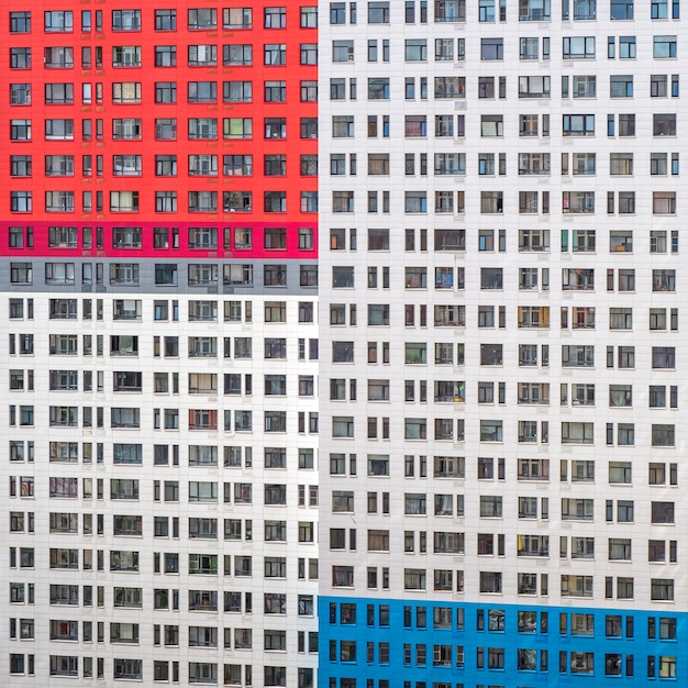 Fragment of a wall with windows of a multi-storey apartment building.