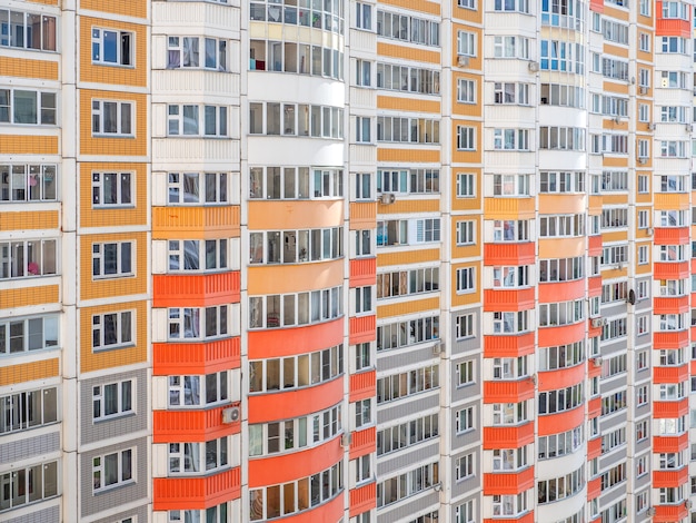 Fragment of a wall with windows of a multi-storey apartment building.