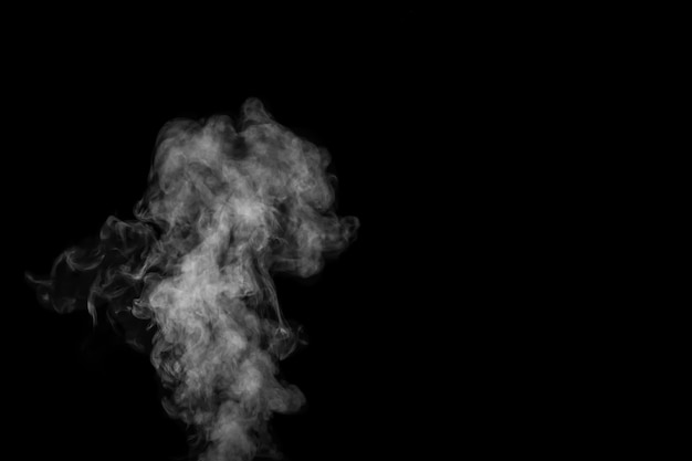 Fragment of white hot curly steam smoke isolated on a black background, close-up. Create mystical Halloween photos. Abstract background, design element