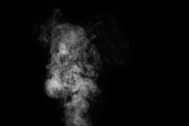 Fragment of white hot curly steam smoke isolated on a black background, close-up. Create mystical Halloween photos. Abstract background, design element