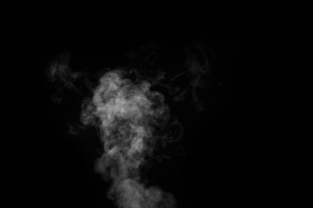 Fragment of white hot curly steam smoke isolated on a black background, close-up. Create mystical Halloween photos. Abstract background, design element