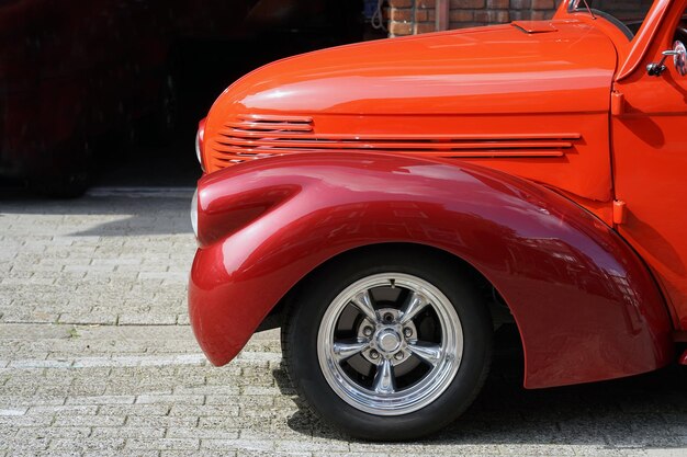 Fragment of the wing of a red car