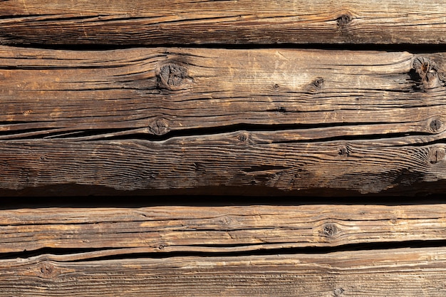 Fragment of a wooden house. Wooden wall from logs as a background texture