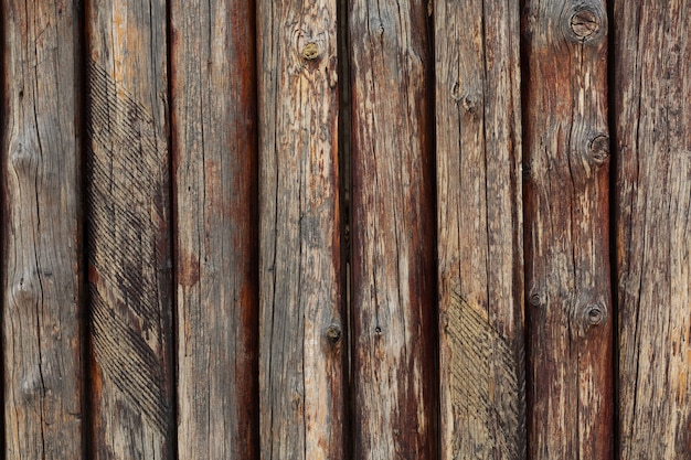 Fragment of wooden old brown fence. Closeup shot