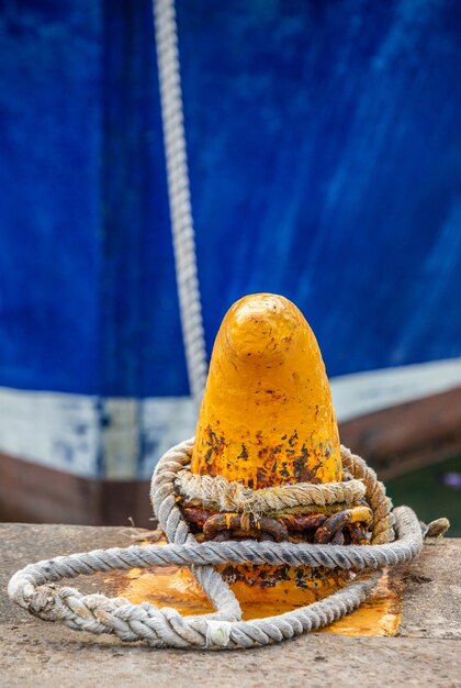 Fragments of the bow of fishing boats tied with ropes to the pier.