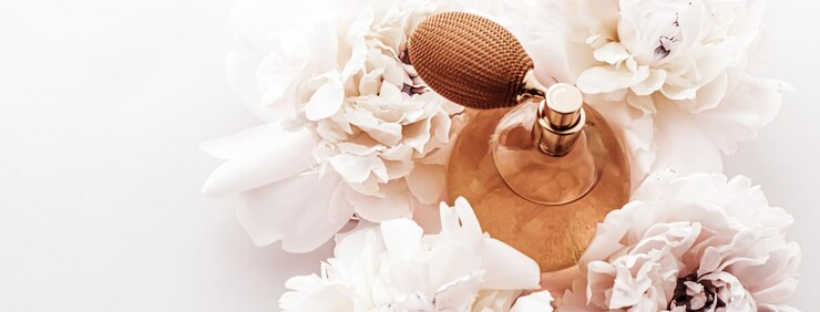 Photo fragrance bottle as vintage perfume product on background of peony flowers parfum ad and beauty branding
