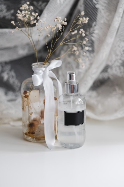 Fragrance spray in transparent plastic bottle with black empty tag